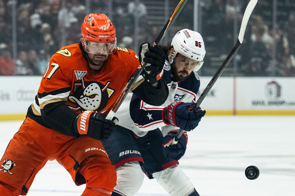 Anaheim Ducks left wing Alex Killorn (17) and Columbus Blue Jackets right wing Kirill Marchenko (86) vie for the puck during the first period of an NHL hockey game, Saturday, Dec. 20, 2025, in Anaheim, Calif. (AP Photo/Kyusung Gong)