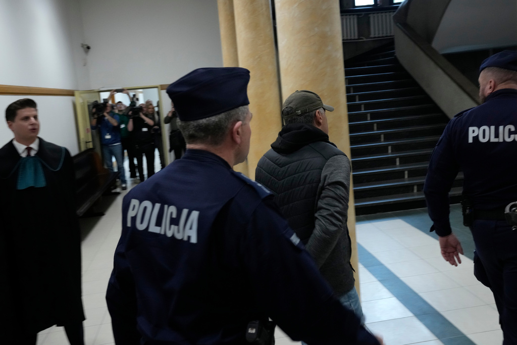 Ukrainian man who has been identified only as Volodymyr Z, second right, who is suspected by German prosecutors of involvement in the 2022 attack on the Nord Stream gas pipelines leaves the courtroom of a regional court in Warsaw ,Poland, Friday, Oct. 17, 2025. (AP Photo/Czarek Sokolowski)