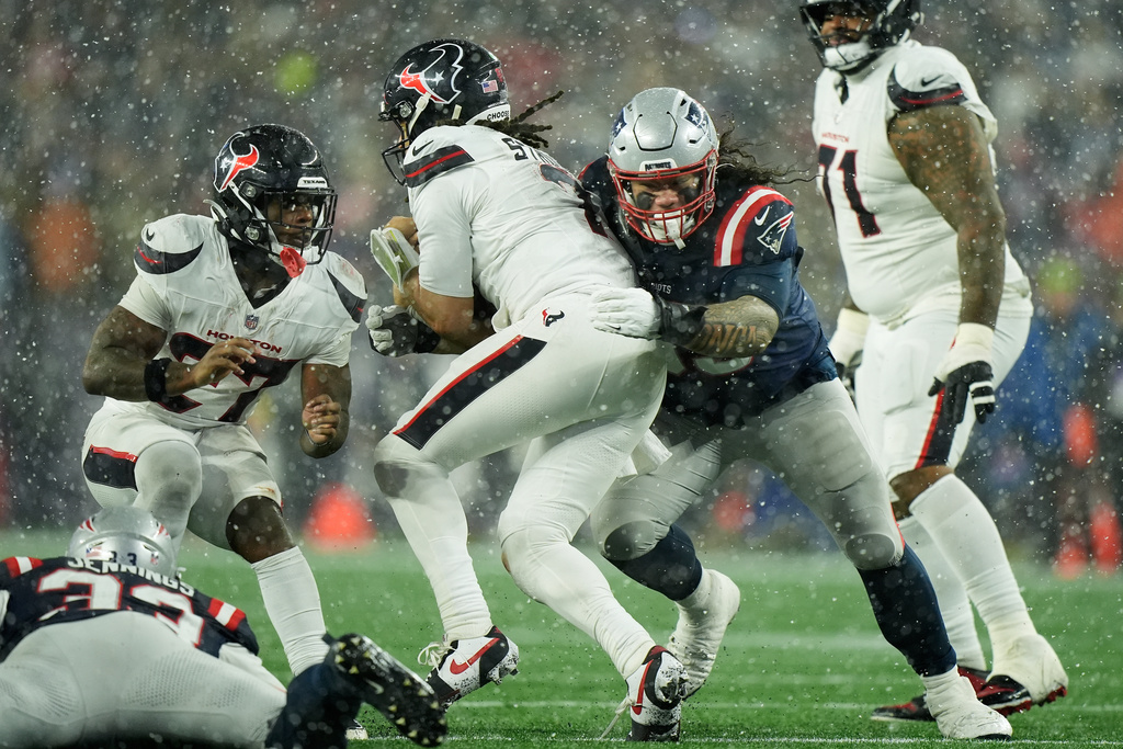New England Patriots defensive tackle Khyiris Tonga, middle right, sacks Houston Texans quarterback C.J. Stroud during the second half of an NFL divisional playoff football game, Sunday, Jan. 18, 2026, in Foxborough, Mass. (AP Photo/Robert F. Bukaty)