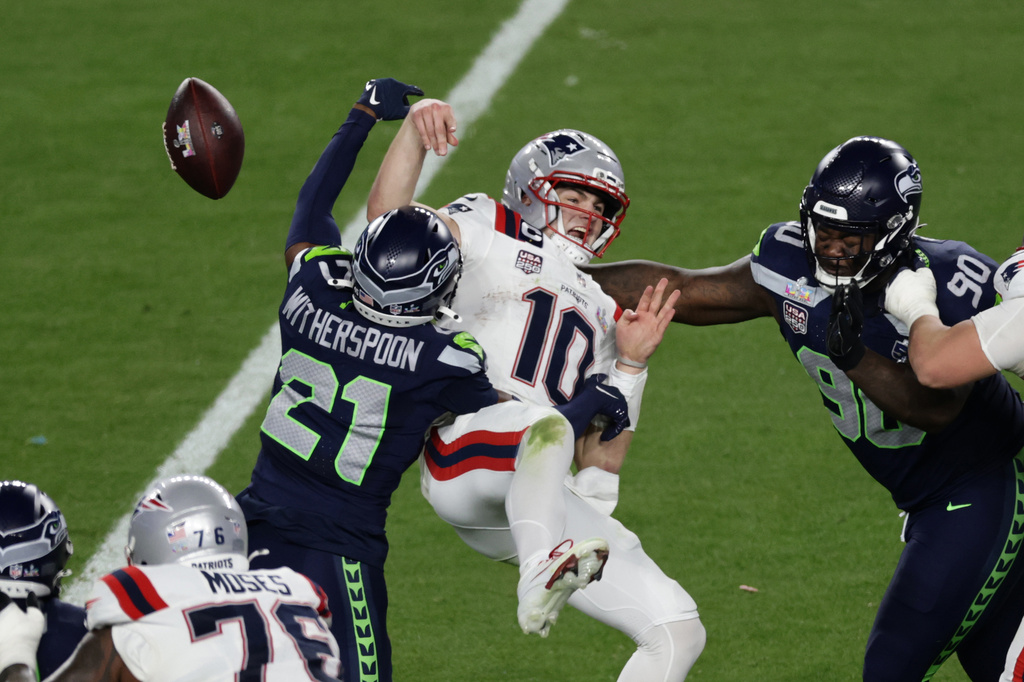 Seattle Seahawks cornerback Devon Witherspoon (21) forces a fumble against New England Patriots quarterback Drake Maye (10) at the NFL Super Bowl 60 game in Santa Clara, Calif., Sunday, February 8, 2026. (Adam Hunger/AP Content Services for the NFL)