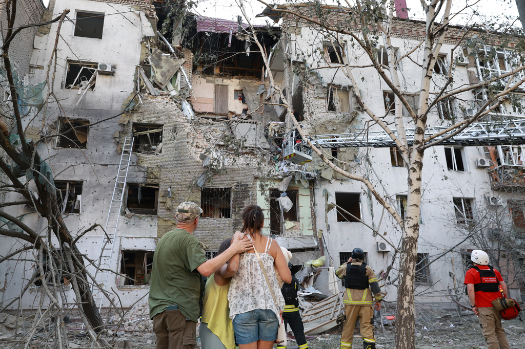 Residents look at their ruined home following a Russian air guided bomb strike in Zaporizhzhia, Ukraine, Sunday, July 19, 2026. (AP Photo/Kateryna Klochko)