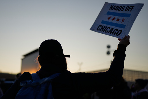 A protester holds a sign outside an ICE processing facility in the Chicago suburb of Broadview, Ill., Friday, Oct. 31, 2025. (AP Photo/Nam Y. Huh) A protester holds a sign outside an ICE processing facility in the Chicago suburb of Broadview, Ill., Friday, Oct. 31, 2025. (AP Photo/Nam Y. Huh)