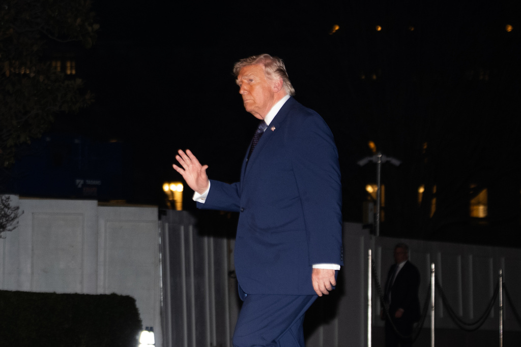President Donald Trump waves on the South Lawn as he returns to the White House following a trip to Florida, Monday, March 9, 2026, in Washington. (AP Photo/Allison Robbert)