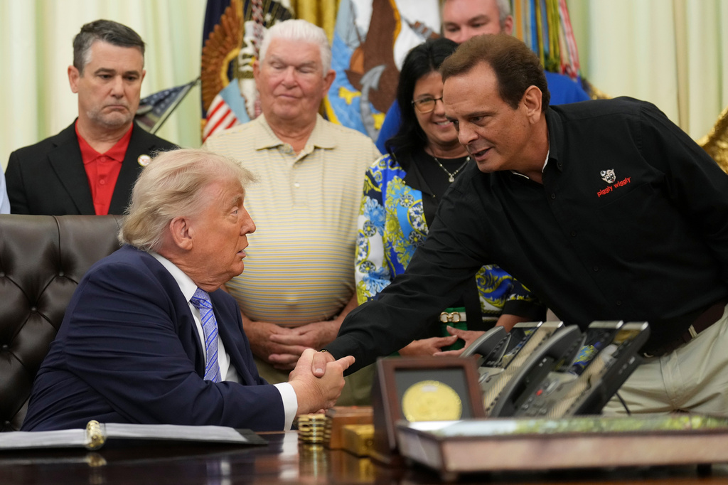 President Donald Trump, left, shakes the hand of Kevin McDaniel, Piggly Wiggly franchise owner, during an event about loosening a federal refrigerant rule, in the Oval Office at the White House, Thursday, May 21, 2026, in Washington. (AP Photo/Jacquelyn Martin)