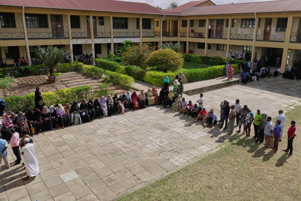 People wait to cast their votes during the general elections at Mpendaye polling station in Zanzibar, Tanzania, Wednesday, Oct. 29, 2025. (AP Photo/Brian Inganga)