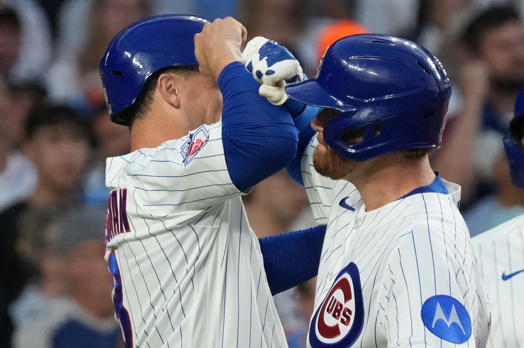 Chicago Cubs' Carson Kelly, right, is greeted by Alex Bregman, left, after hitting a two-run home run against the Los Angeles Dodgers during the third inning of a baseball game Monday, Aug. 3, 2026, in Chicago. (AP Photo/David Banks)