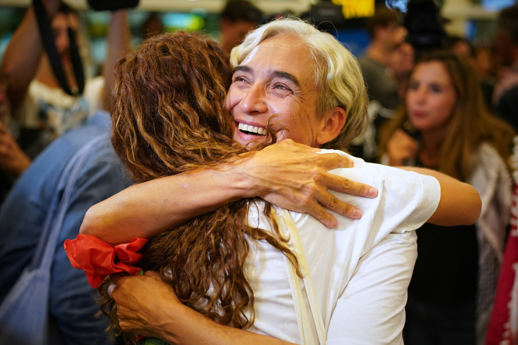 Former Barcelona mayor Ada Colau is embraced by a friend as she arrives at the airport in Barcelona, Spain, Sunday, Oct. 5, 2025, after being arrested on the Global Sumud Flotilla and subsequently released by the Israeli authorities. (AP Photo/Joan Mateu Parra)