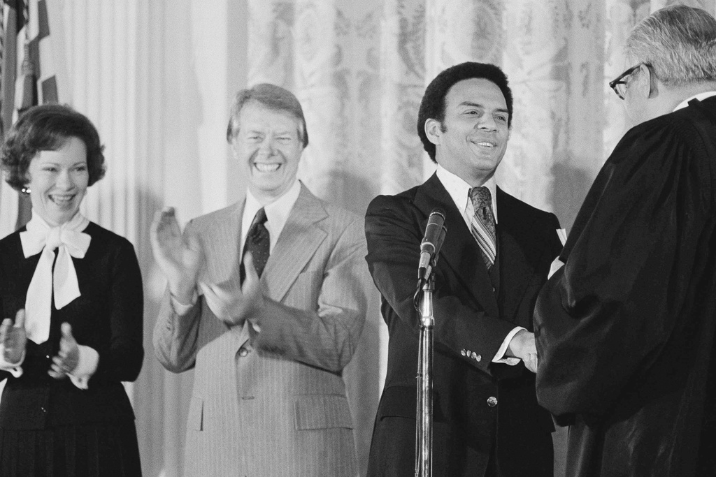 FILE - United Nations Ambassador Andrew Young receives congratulations from Justice Thurgood Marshall after he was sworn in during ceremonies at the White House, Jan. 30, 1977. President Jimmy Carter and first lady Rosalynn Carter applaud the new ambassador. (AP Photo, File)