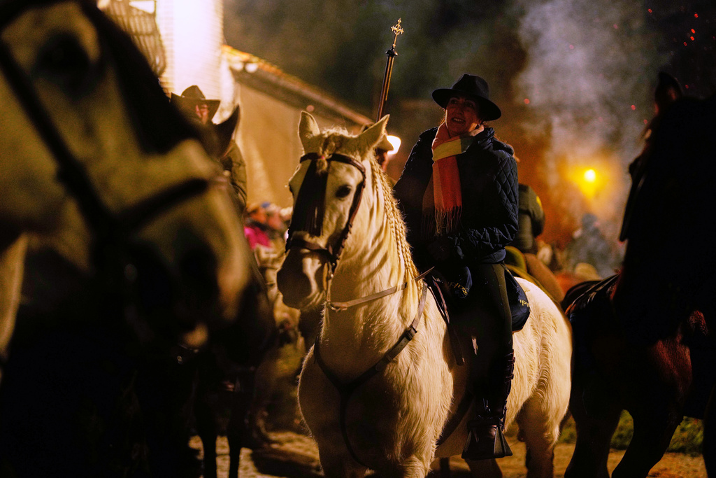 Riders on their horses wait to jump over the bonfires as part of a ritual in honor of Saint Anthony the Abbot, the patron saint of domestic animals, in San Bartolome de Pinares, Spain, Friday, Jan. 16, 2026. (AP Photo/Manu Fernandez)