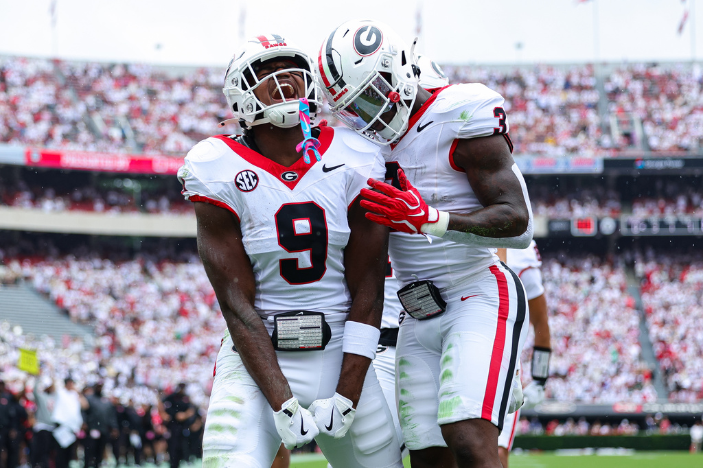Georgia tight end Ethan Barbour (9) reacts with running back Nate Frazier, right, after scoring a touchdown during the first half of an NCAA college football game against Western Kentucky, Saturday, Sept. 12, 2026, in Athens, Ga. (AP Photo/Colin Hubbard)