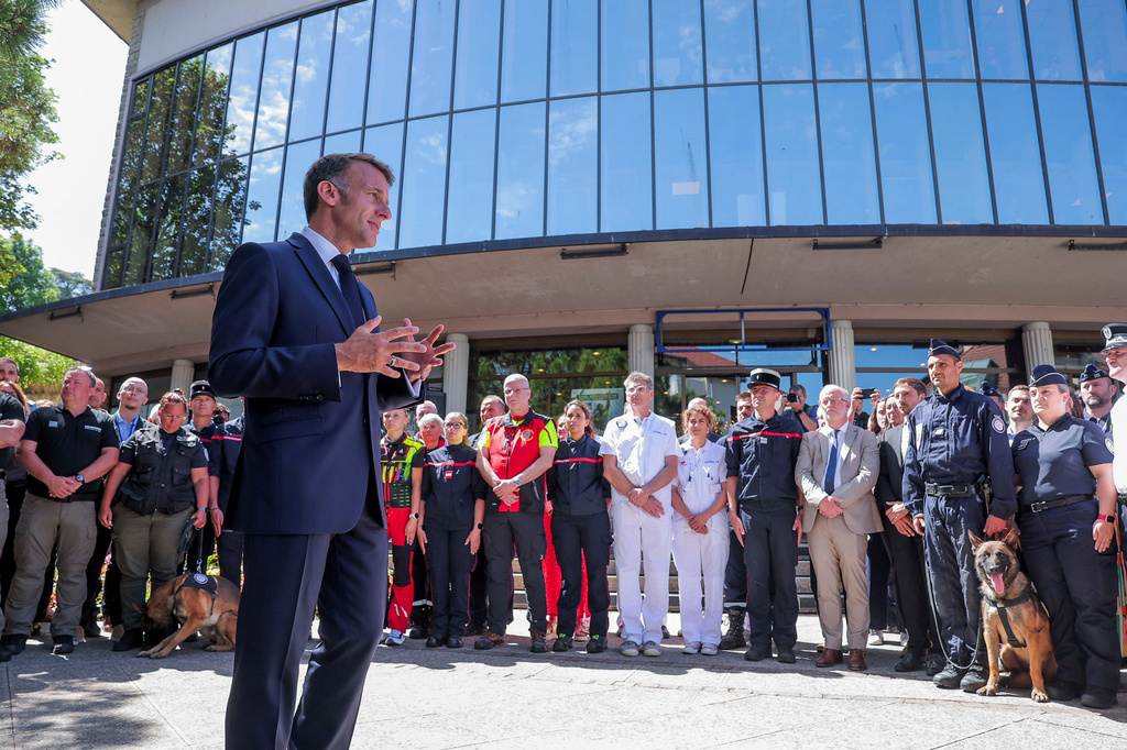 French President Emmanuel Macron meets members of the emergency forces, ahead of the G7 Summit, in Evian-les-Bains, France, Monday, June 15, 2026. (Christian Hartmann/Pool Photo via AP)