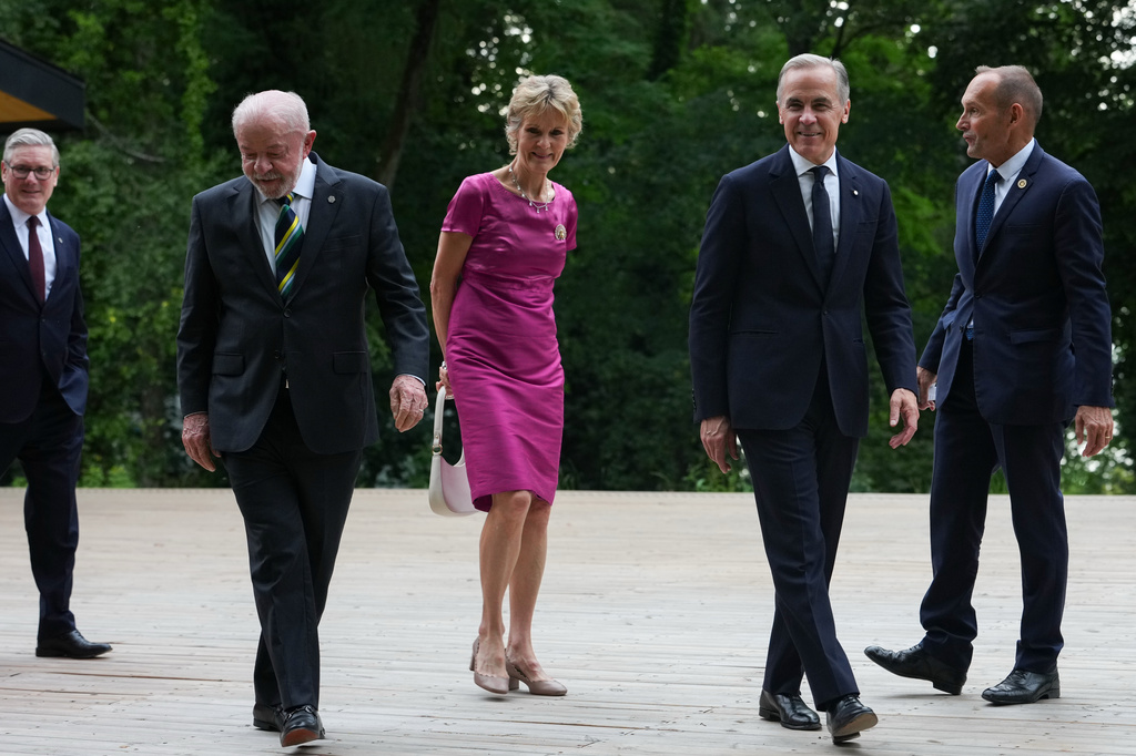 Britain's Prime Minister Keir Starmer, left, Brazil's President Luiz Inacio Lula da Silva, second from left, and Canada's Prime Minister Mark Carney, second from right, arrive for a group photo at the G7 summit, Tuesday, June 16, 2026, in Evian-les-Bains, France. (AP Photo/Julia Demaree Nikhinson)