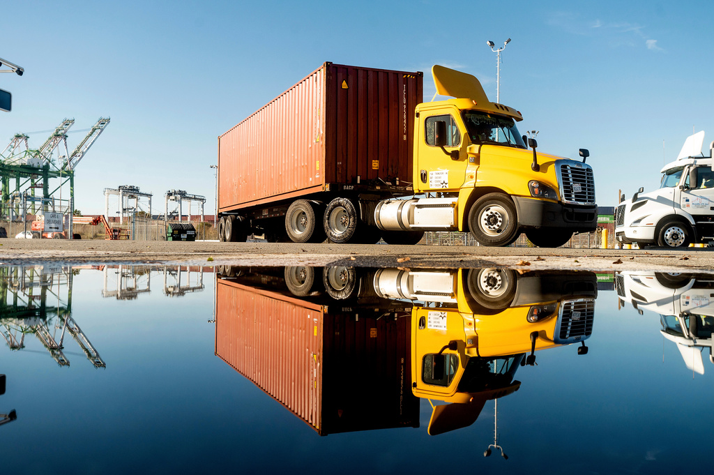 FILE - A truck departs from a Port of Oakland shipping terminal on Nov. 10, 2021, in Oakland, Calif. (AP Photo/Noah Berger, File)