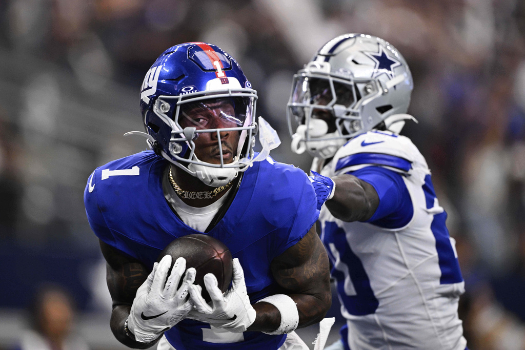 New York Giants wide receiver Malik Nabers (1) catches a pass as Dallas Cowboys cornerback Kaiir Elam (20) defends in the second half of an NFL football game Sunday, Sept. 14, 2025, in Arlington, Texas. (AP Photo/Jerome Miron)