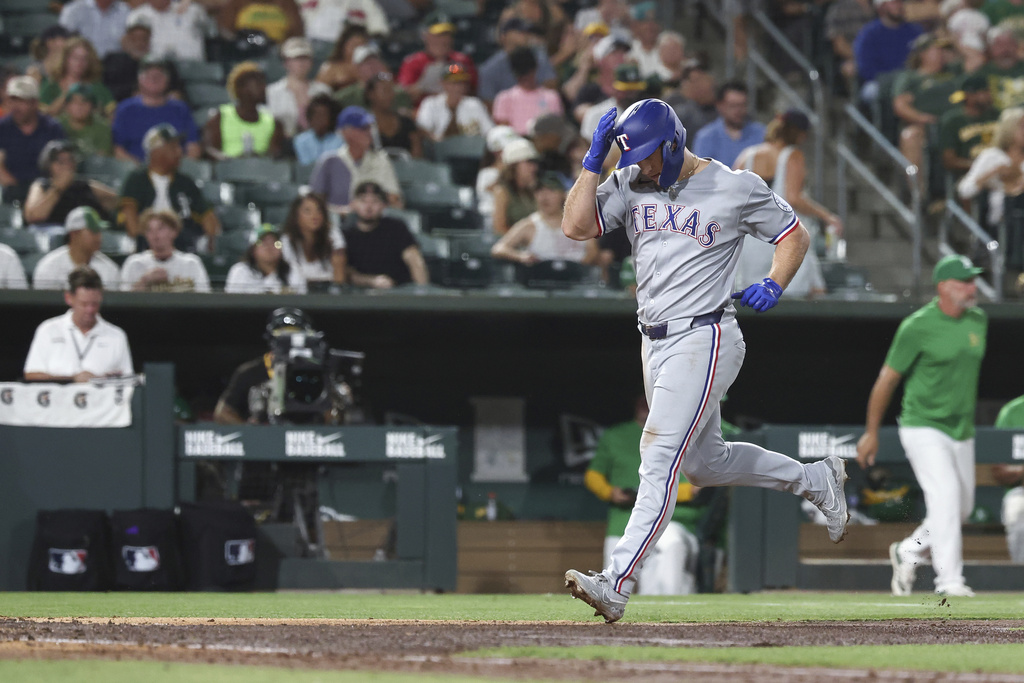 Texas Rangers' Wyatt Langford runs the bases after hitting a solo home run during the fifth inning of a baseball game against the Athletics Saturday, Aug. 30, 2025, in West Sacramento, Calif. (AP Photo/Sara Nevis)