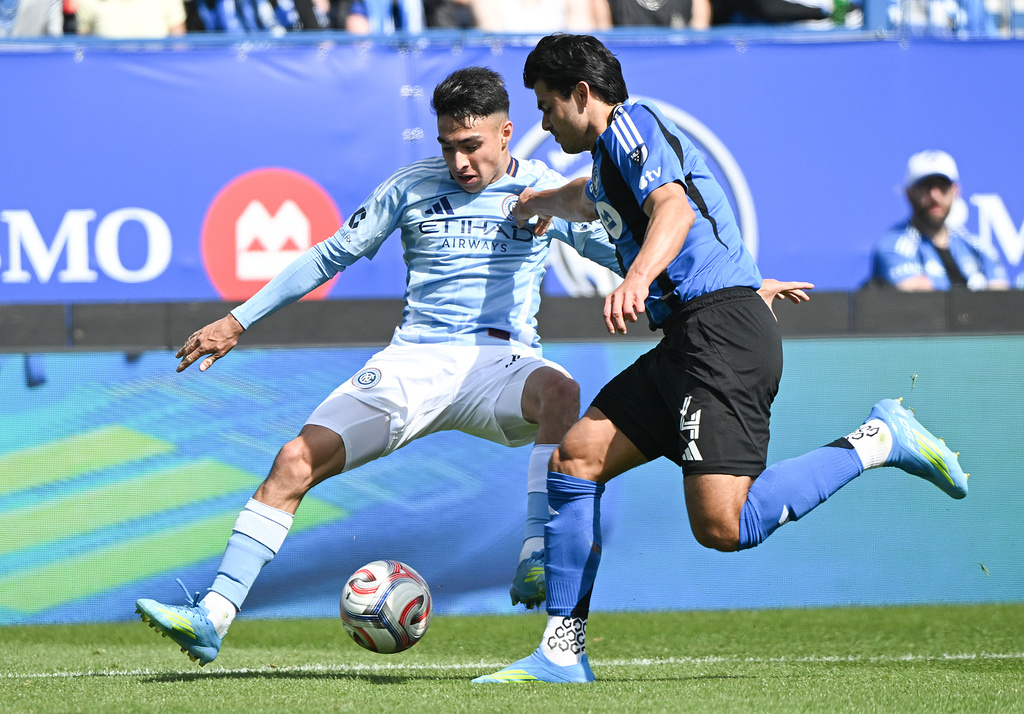 CF Montreal's Brayan Vera (4) challenges for ball with New York City's Agustin Ojeda (26) during the first half of a MLS soccer game in Montreal, Saturday, April 25, 2026.(Graham Hughes/The Canadian Press via AP)