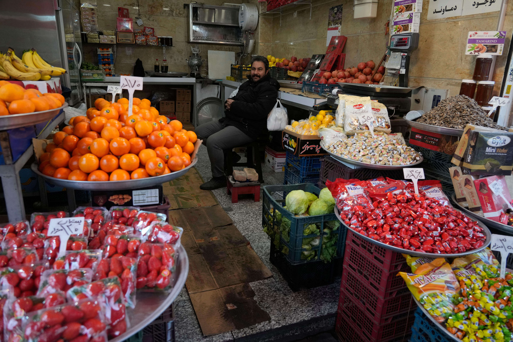 A fruit seller waits for customer at Tehran's historic Grand Bazaar, Tuesday, Jan. 20, 2026, in Iran. (AP Photo/Vahid Salemi)