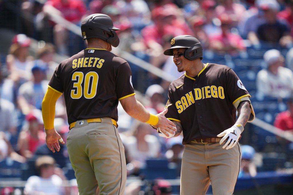 San Diego Padres' Manny MacHado, right, celebrates his two-run home run with teammate Gavin Sheets, during the seventh inning of a baseball game against the Philadelphia Phillies, Thursday, June 4, 2026, in Philadelphia. (AP Photo/Matt Rourke)