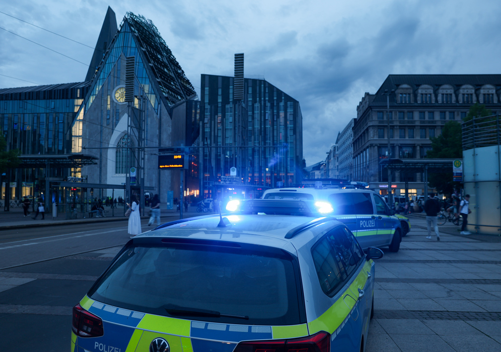 Emergency services stand at the entrance to Grimmaische station in Leipzig, Germany, Monday, May 4, 2026. (Jan Woitas/dpa via AP)