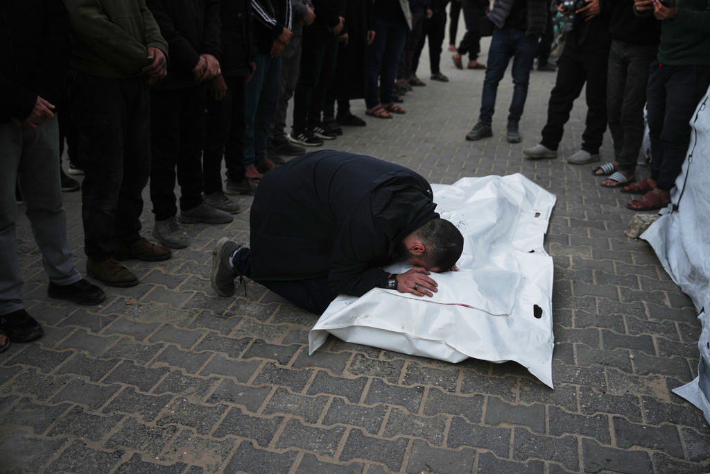 Palestinians mourn the body of Saeed Al-Jaro, killed in an Israeli military strike, during his funeral at Al-Aqsa Hospital in Deir al-Balah, Gaza Strip Thursday, Jan. 15, 2026. (AP Photo/Abdel Kareem Hana)