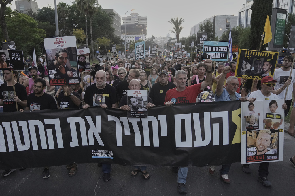 Relatives and supporters of hostages held by Hamas take part in a protest demanding their immediate release and calling for the end of the war in the Gaza Strip, as they march in Tel Aviv, Israel, Thursday, Aug. 21, 2025. (AP Photo/Mahmoud Illean)