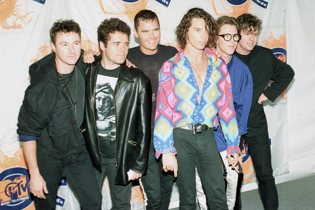 FILE - Members of the Australian rock group INXS, from left, Garry Gary Beers, Andrew Farriss, Jon Farriss, Michael Hutchence, Kirk Pengilly and Tim Farriss appear at the 7th annual American MTV Video Music Awards in Universal City, Calif., on Sept. 6, 1990. (AP Photo/Kevork Djansezian, File)