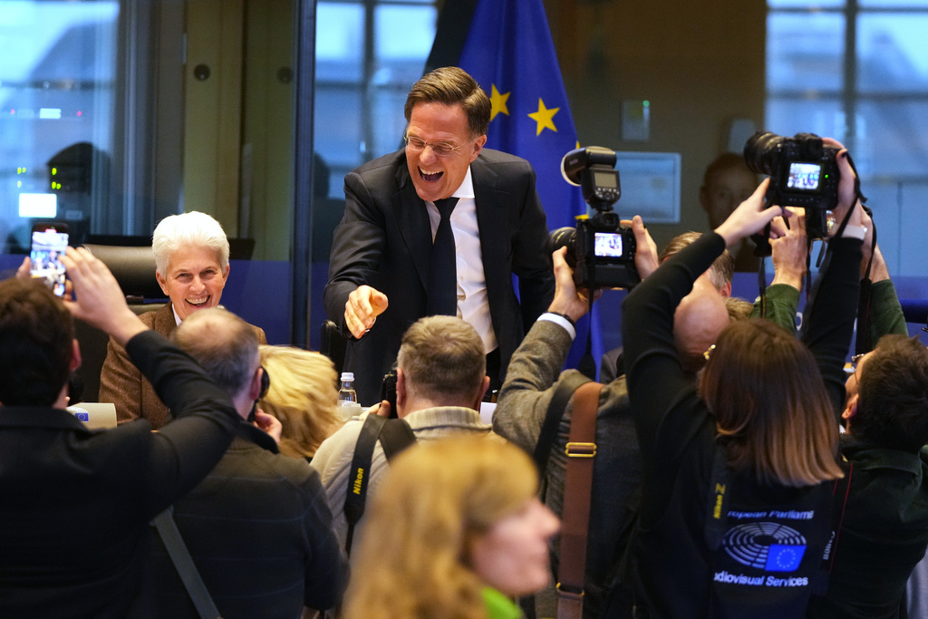 NATO Secretary General Mark Rutte, center, greets the audience prior to his address during the Security and Defence Committee at the European Parliament in Brussels, Monday, Jan. 26, 2026. (AP Photo/Virginia Mayo)