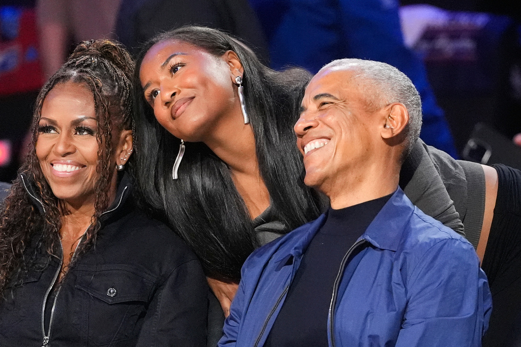 From left, Michelle Obama, Sasha Obama and Barack Obama pose for a photo before the NBA All-Star basketball game Sunday, Feb. 15, 2026, in Inglewood, Calif. (AP Photo/Mark J. Terrill)