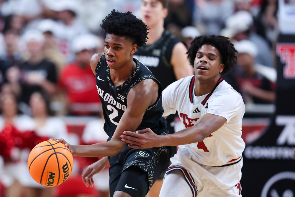 Colorado guard Isaiah Johnson (2) works around Texas Tech guard Christian Anderson (4) during the first half of an NCAA college basketball game, Wednesday, Feb. 11, 2026, in Lubbock, Texas. (AP Photo/Chase Seabolt)