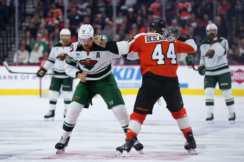 Philadelphia Flyers' Nicolas Deslauriers, right, and Minnesota Wild's Marcus Foligno (44) fight during the first period of an NHL hockey game, Saturday, Oct. 18, 2025, in Philadelphia. (AP Photo/Derik Hamilton)
