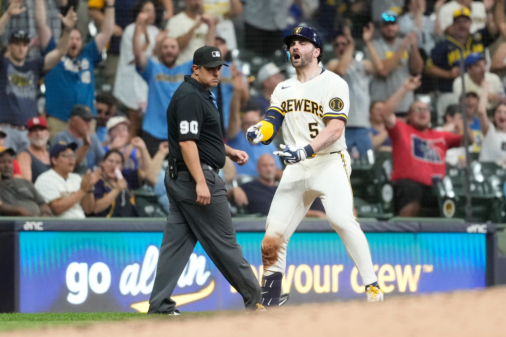 Milwaukee Brewers' Garrett Mitchell reacts after hitting an RBI triple during the seventh inning of a baseball game against the Cincinnati Reds, Wednesday, July 1, 2026, in Milwaukee. (AP Photo/Aaron Gash)