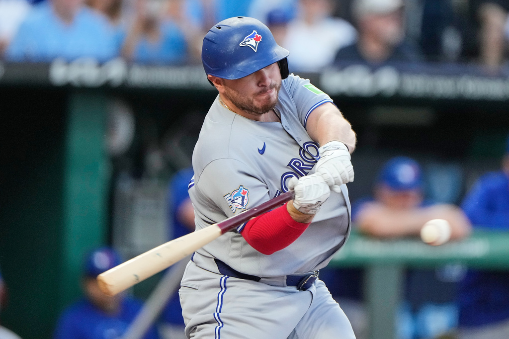 Toronto Blue Jays' Alejandro Kirk hits an RBI single during the first inning of a baseball game against the Kansas City Royals, Friday, Sept. 4, 2026, in Kansas City, Mo. (AP Photo/Charlie Riedel)