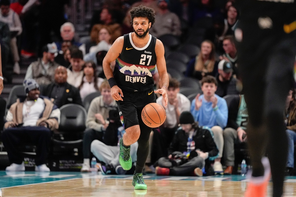 Denver Nuggets guard Jamal Murray (27) brings the ball upcourt against the Charlotte Hornets during the first half of an NBA basketball game in Charlotte, N.C., Sunday, Dec. 7, 2025. (AP Photo/Jim Dedmon)