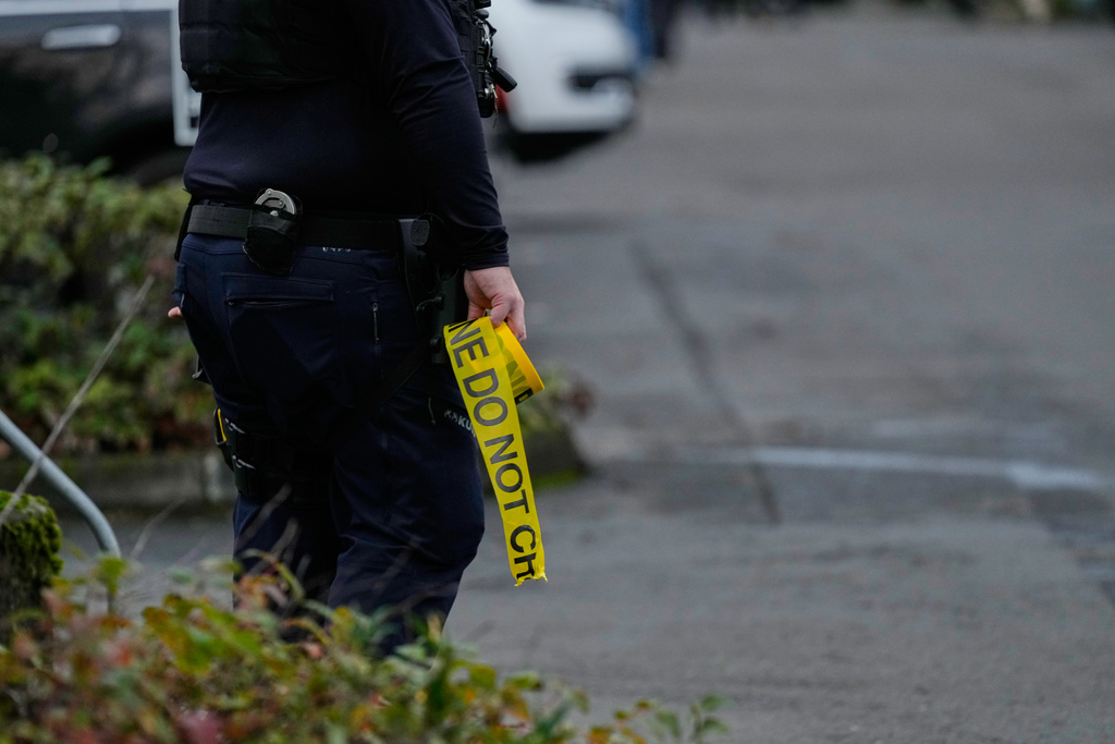Law enforcement officials work the scene following reports that federal immigration officers shot and wounded people in Portland, Ore., Thursday, Jan. 8, 2026. (AP Photo/Jenny Kane)