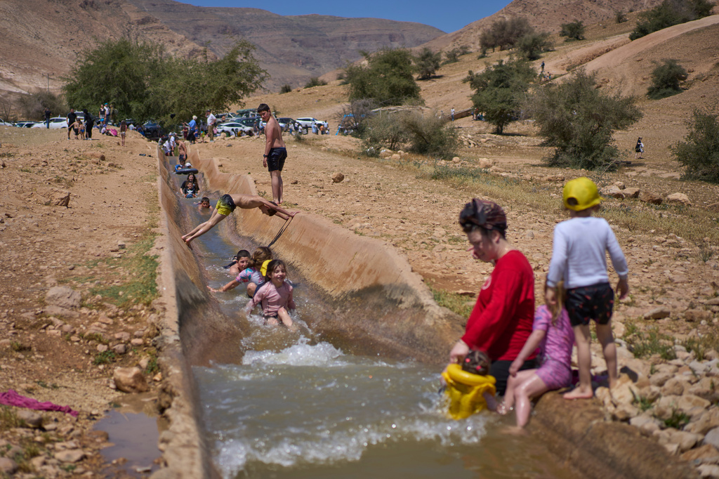 Israelis enjoy a day at a spring in Auja, in the Jordan Valley, during Israel's Independence Day on Wednesday, April 22, 2026, in the occupied West Bank. (AP Photo/Ohad Zwigenberg)