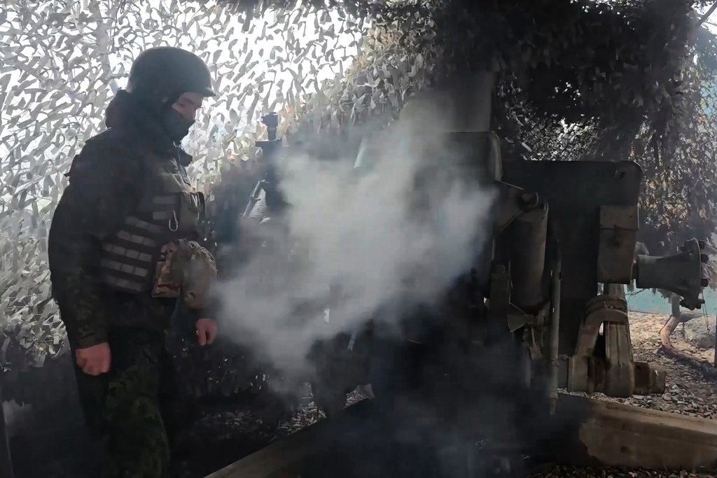 In this image made from video provided by the Russian Defense Ministry Press Service on Tuesday, Dec. 30, 2025, a Russian Army soldier fires from D-30 howitzer towards Ukrainian positions in an undisclosed location in Ukraine. (Russian Defense Ministry Press Service via AP)