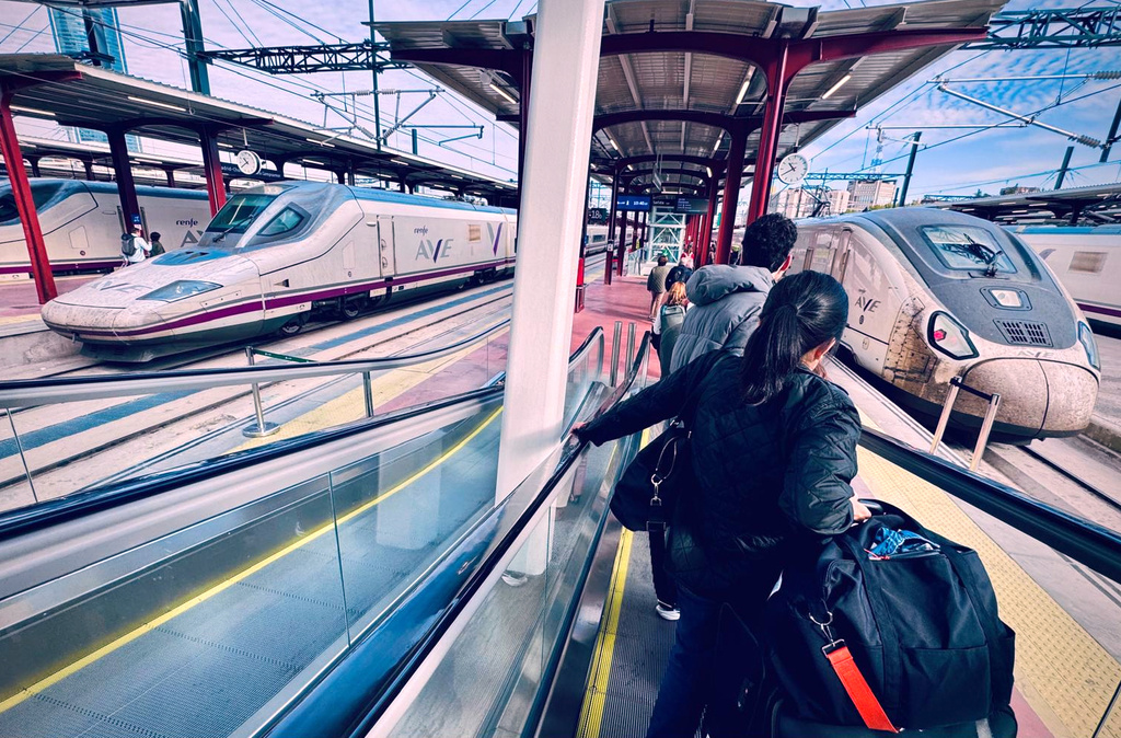 Passengers head to board their trains at Atocha railway station in Madrid, Spain, Friday, Oct. 30, 2026. (AP Photo/Maria Gestoso) Photo taken with a smartphone.