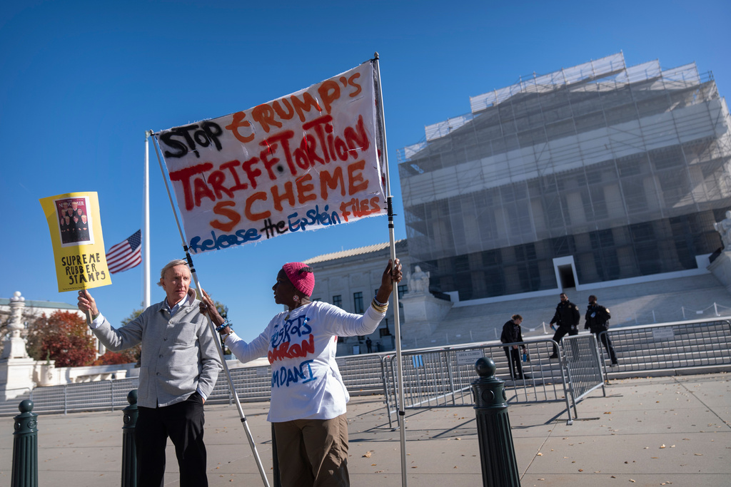 Protesters stand outside the Supreme Court on Wednesday, Nov. 5, 2025, in Washington. (AP Photo/Mark Schiefelbein)