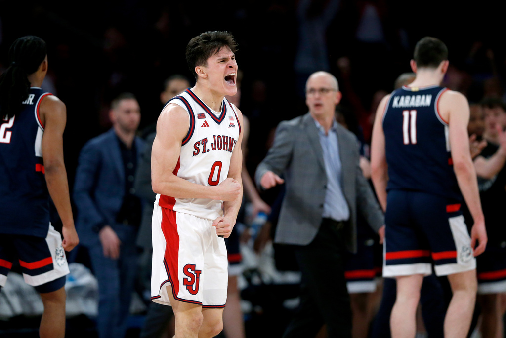 St. John's guard Dylan Darling (0) celebrates after a big defensive play during the second half of an NCAA college basketball game against UConn, Friday, Feb. 6, 2026, in New York. (AP Photo/John Munson)