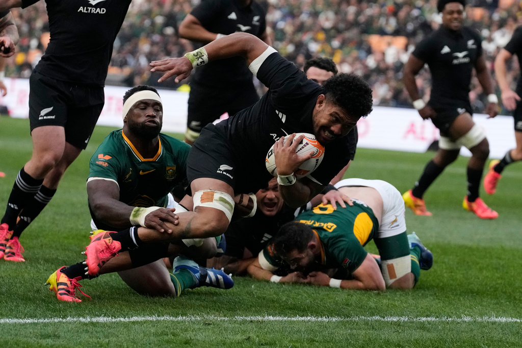 New Zealand's captain Ardie Savea, front, breaks away from South Africa's captain Siya Kolisi, to score a try during a third international test rugby match between South Africa and New Zealand, in Johannesburg, South Africa, Saturday, Sept. 5, 2026. (AP Photo/Themba Hadebe)
