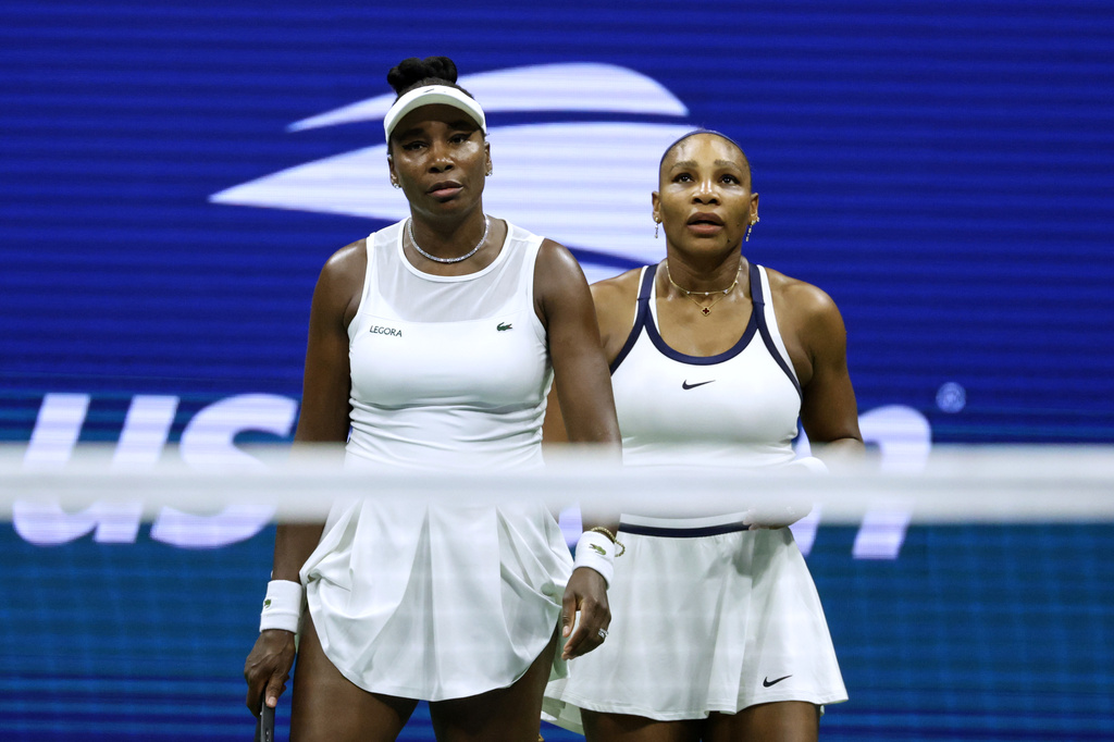 Venus Williams, left, and Serena Williams, of the United States, look on as they play against Hao-Ching Chan, of Taiwan, and Maya Joint, of Australia, during a women's doubles match at the U.S. Open tennis championships, Friday, Sept. 4, 2026, in New York. (AP Photo/Adam Hunger)