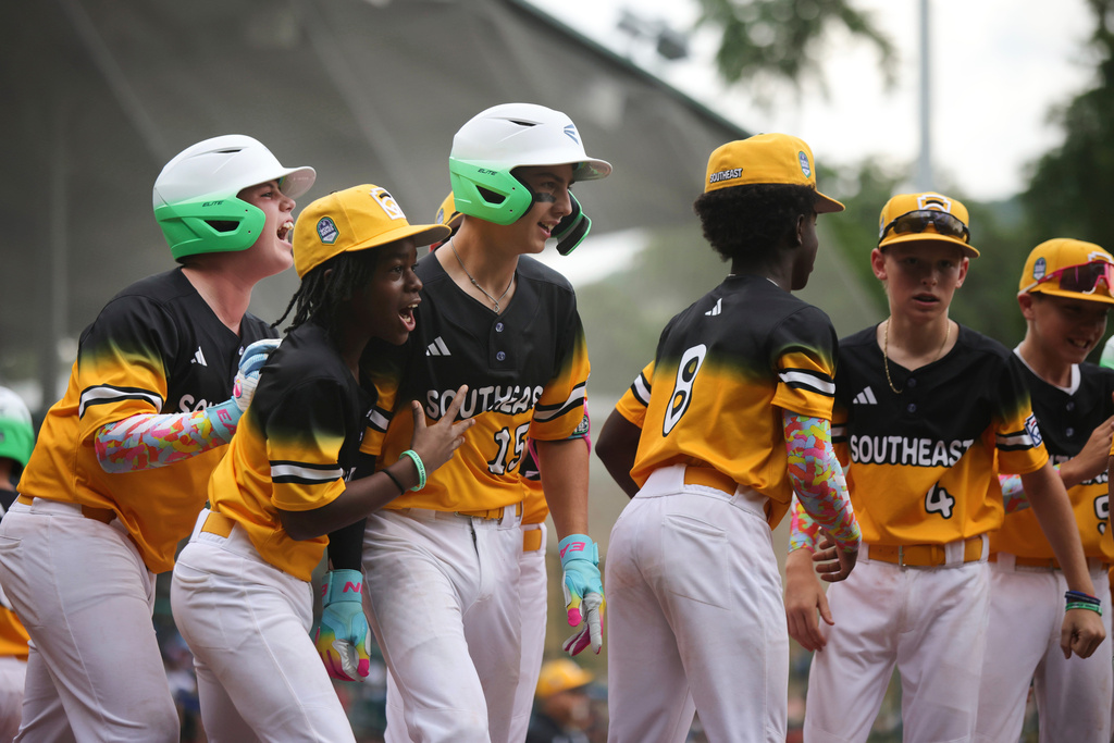 Irmo, S.C.'s Joe Giulietti, center, is greeted by teammates after hitting a home run against Braintree, Mass., during the second inning of a baseball game at the Little League World Series, Thursday, Aug. 14, 2025, in South Williamsport, Pa. (AP Photo/Jared Freed)