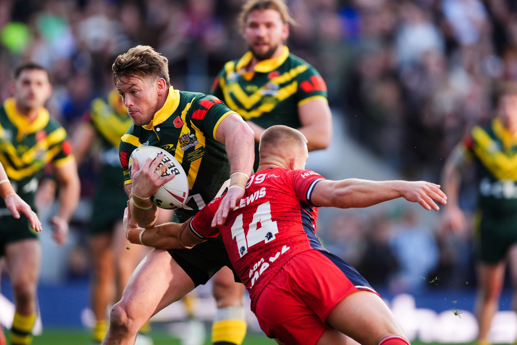 Australia's Harry Grant (left) is tackled by England's Mikey Lewis during the rugby League Ashes series match between England and Australia, in Leeds, England, Saturday Nov. 8, 2025. (Mike Egerton/PA via AP)