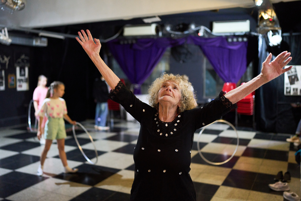 Retiree Delia Donn, 78, a regular at weekly protests outside Congress calling for better pensions, dances at the cultural center "El Donn," which she helps her son run in memory of her late brother, a renowned classical dancer, in Buenos Aires, Argentina, Friday, Sept. 26, 2025. (AP Photo/Rodrigo Abd)