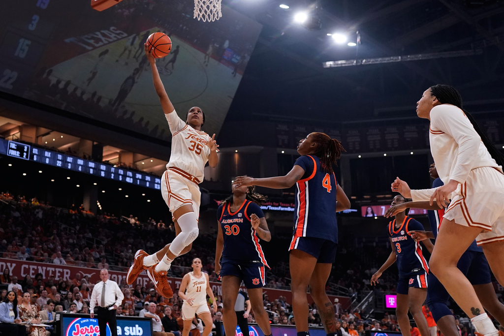 Texas forward Madison Booker (35)drives to the basket against Auburn forward Clara Koulibaly (30) and guard Kaitlyn Duhon (4) during the second half of an NCAA college basketball game in Austin, Texas, Thursday, Jan. 8, 2026. (AP Photo/Eric Gay)
