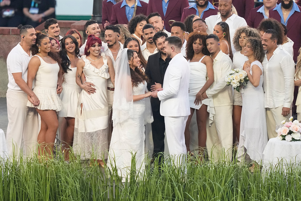 A couple dressed as a bride and groom participate in the Bad Bunny performance during halftime of the NFL Super Bowl 60 football game between the Seattle Seahawks and the New England Patriots, Sunday, Feb. 8, 2026, in Santa Clara, Calif. (AP Photo/Frank Franklin II)