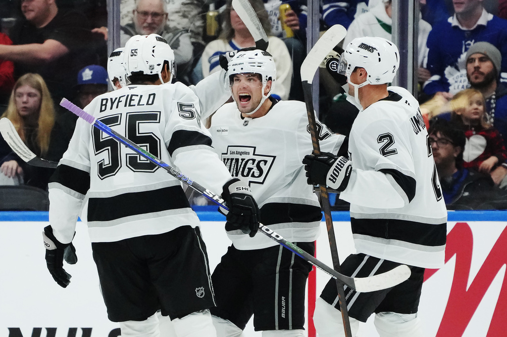 Los Angeles Kings' Kevin Fiala (second right) celebrates his goal against the Toronto Maple Leafs with Quinton Byfield (55) and Brian Dumoulin (2) during second period NHL hockey in Toronto on Thursday, Nov. 13, 2025. (Nathan Denette/The Canadian Press via AP)