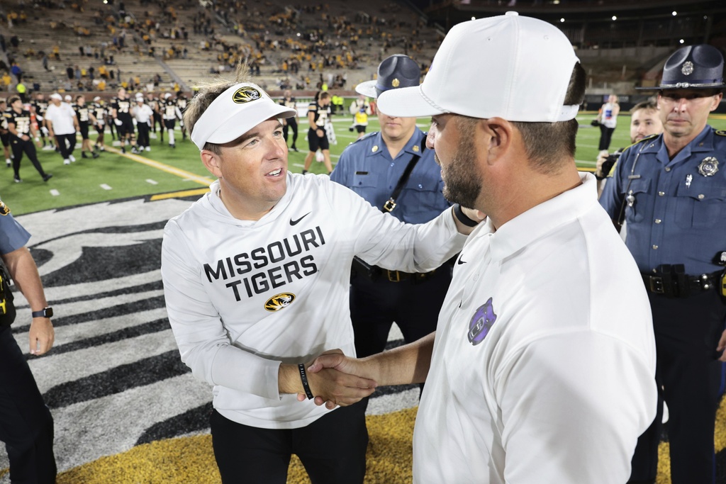 Missouri Tigers head coach Eli Drinkwitz shakes hands with Central Arkansas head coach Nathan Brown after after an NCAA college football game in Columbia, Mo., on Thursday, Aug. 28, 2025. (Liz Rymarev/St. Louis Post-Dispatch via AP)