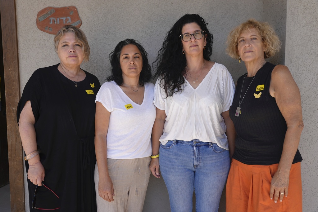 From left: Noorit Felsenthal-Berger, Bat El, Yifat Gadot, Paula Keusch, mothers of soldiers who have fought in Gaza, pose for a photo outside a house in Tal Shahar, central Israel, Saturday Aug. 23, 2025. (AP Photo/Sam Mednick)