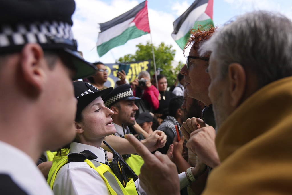 Protesters argue with police officers during a protest to support Palestine Action in London, Saturday, Sept. 6, 2025.(AP Photo/Joanna Chan)